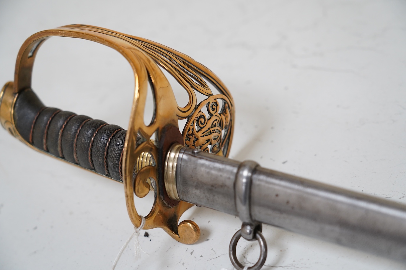 A Victorian 1845 pattern British Infantry Officer’s sword, by Hills Brothers of Old Bond Street, London, solid brass hilt in its steel dress scabbard, blade 81cm. Condition - fair, generally worn.